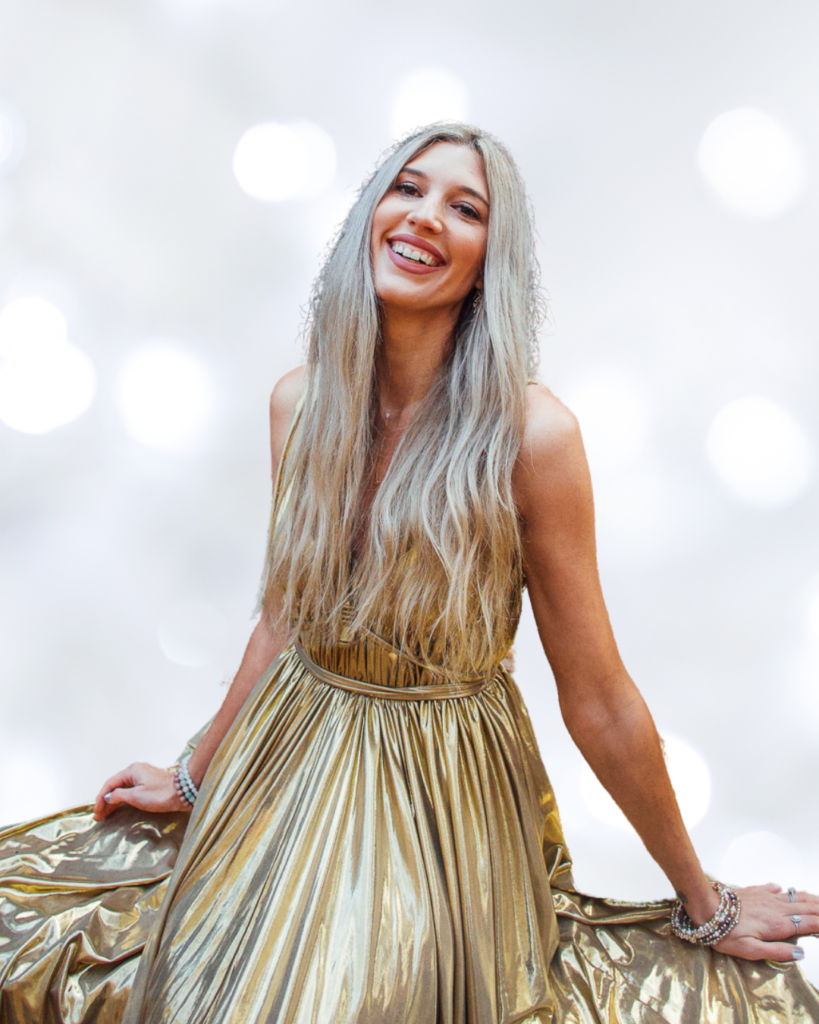 Allie in gold dress looking like a goddess smiling