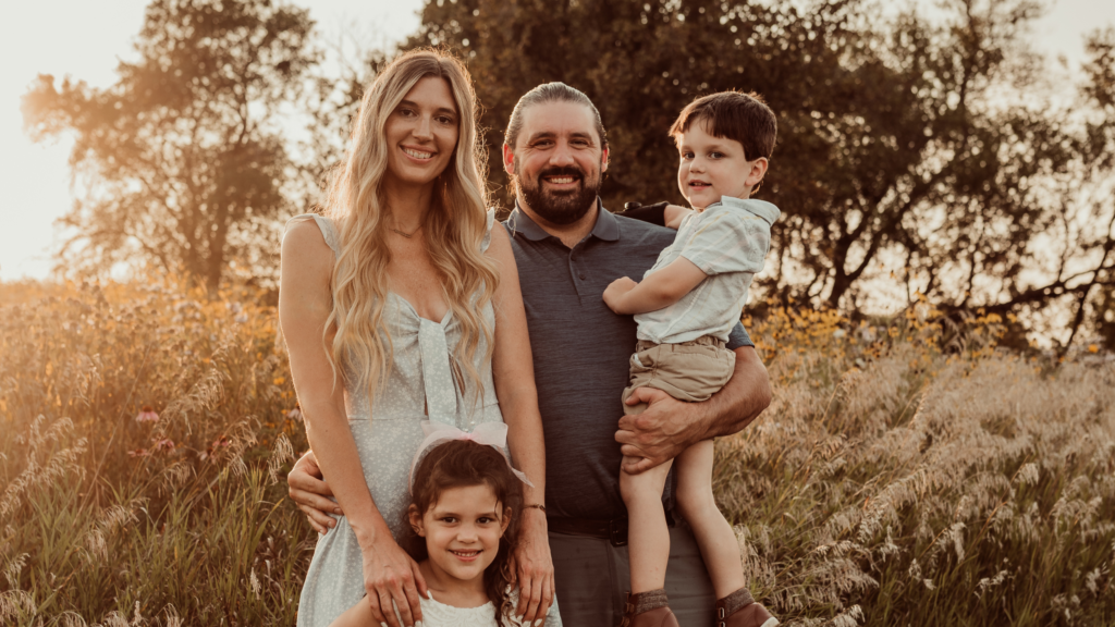 A photo of Allie, her husband and two kids, showcasing how she manifested a family after learning how to set intentions