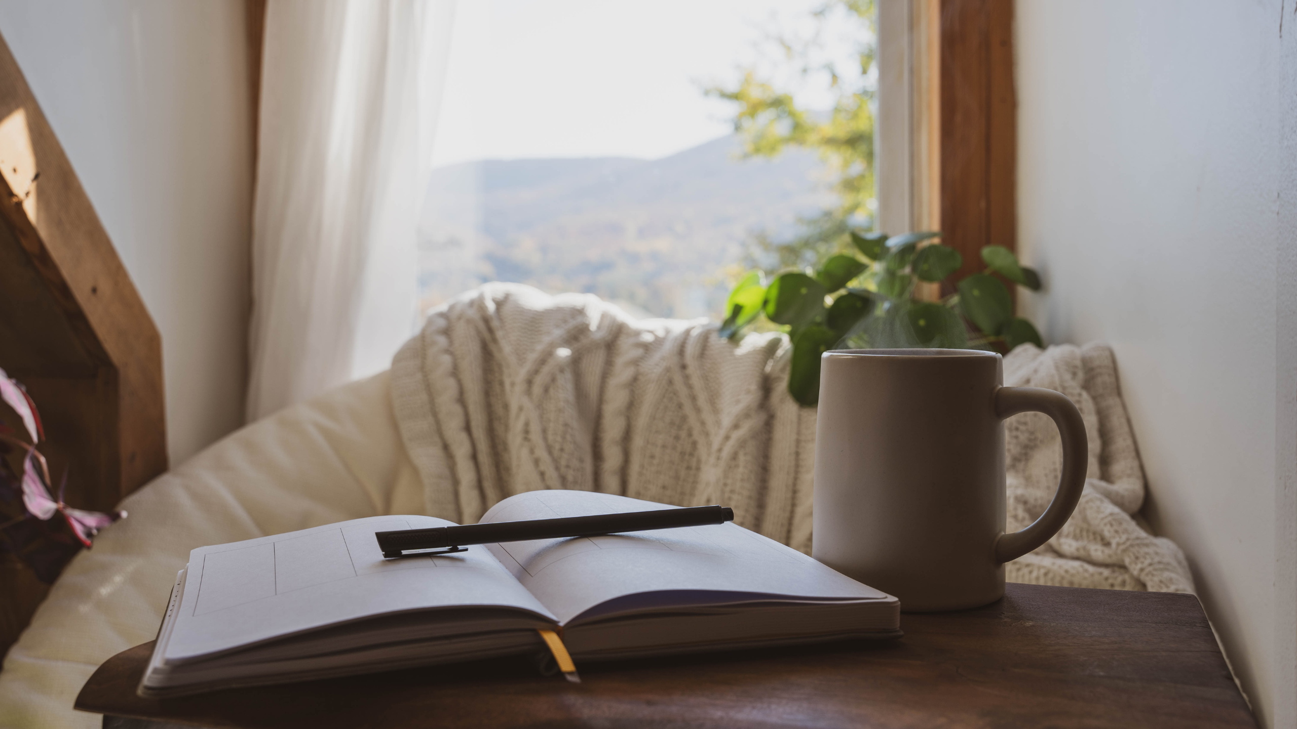 A cozy mental health break with an open journal, pen, and coffee cup, to journal out setting boundaries in relationships