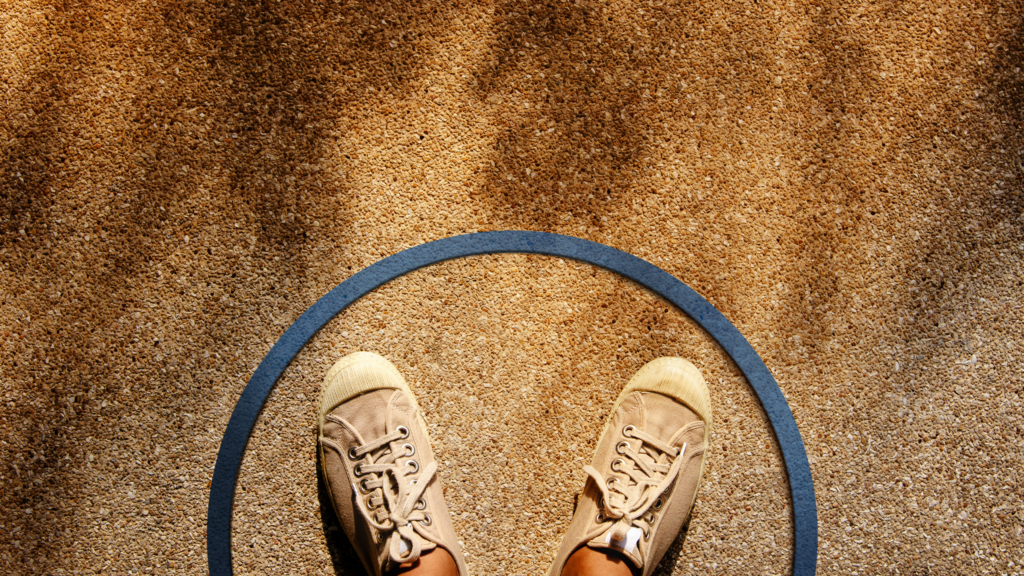 Female in sneaker shoes standing inside a circle line, Top View, On Concrete Floor, With Sunlight as background, representing setting boundaries in relationships